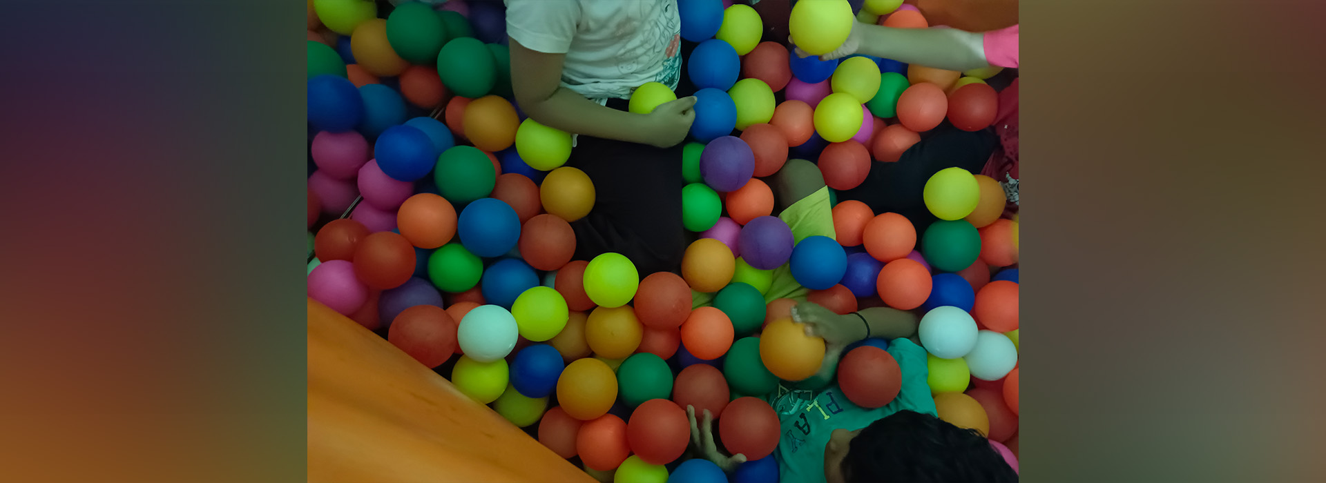 Kids having fun while playing in a ball pit.